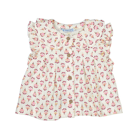 White shirt with pink flowers printed. Ruffle sleeves and buttons down the middle. 