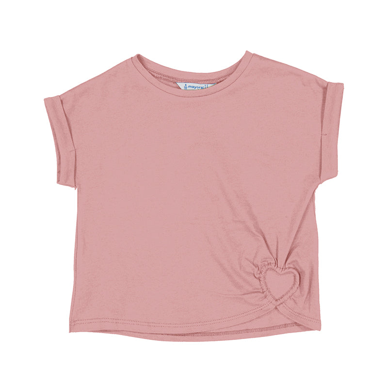 blush colored shirt with a heart cut out at the bottom of the shirt.