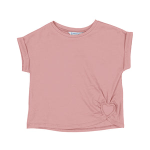 blush colored shirt with a heart cut out at the bottom of the shirt.