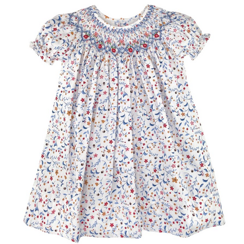short sleeve bishop with floral print in blues and reds and  golds with blue smocking and red rosettes