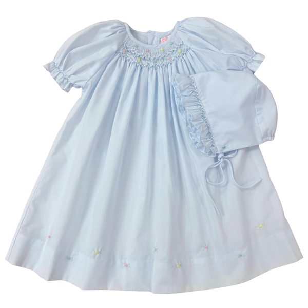Light blue smocked baby dress with ruffled sleeves on a white background matching bonnet on preemie and newborn only