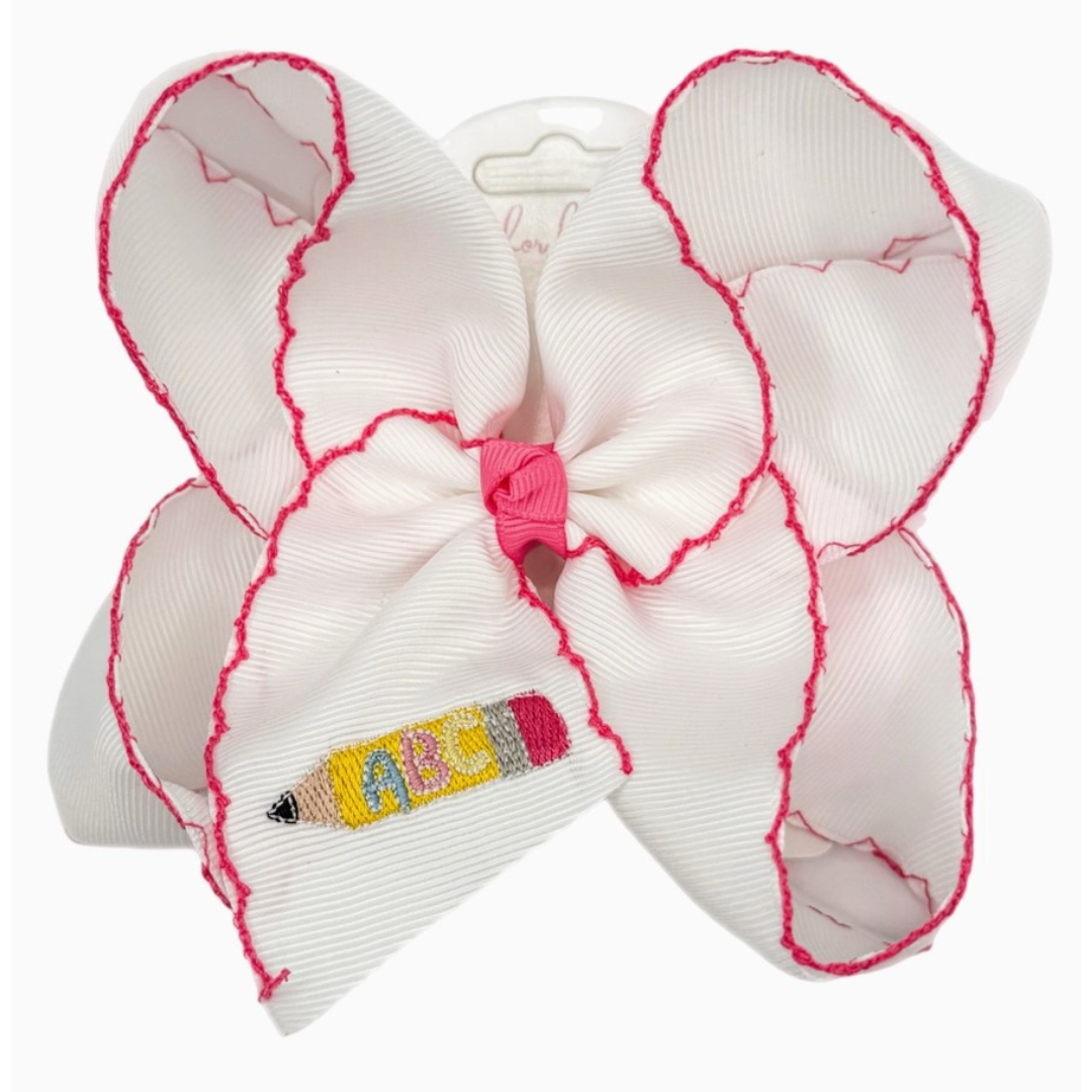 White grosgrain hair bow with hot pink stitched edges and embroidered yellow pencil featuring ABC lettering on the tail.