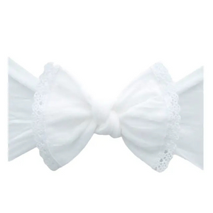 White bow with lace details on a white background