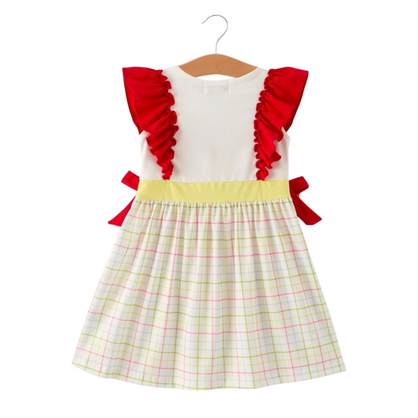 Back view of girls’ dress featuring red ruffle sleeves, yellow waistband, and pastel plaid skirt with red side bows.