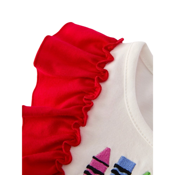 Close-up of bright red ruffle sleeve detail on white bodice of a girls’ back-to-school dress.