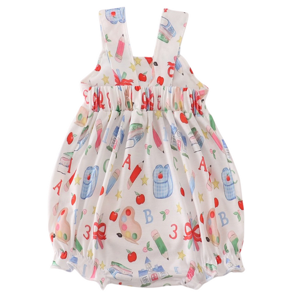 Back view of school-print romper with gathered waist and wide shoulder straps in soft, breathable fabric.