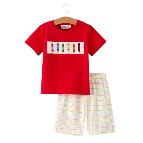 Front view of boys’ red short-sleeve tee with embroidered crayons on chest, paired with pastel plaid shorts.