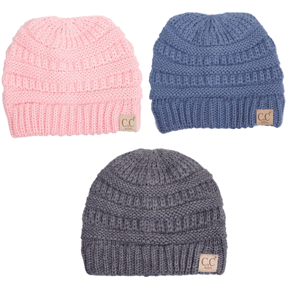 Three knit beanie hats in pink, blue, and gray with visible brand logos on a white background.