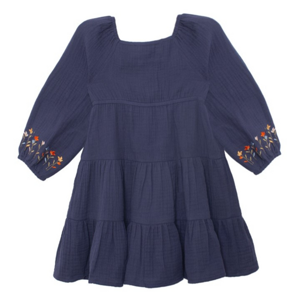 Flat lay back view of navy muslin dress with tiered ruffle design and floral embroidery on the sleeve cuffs.