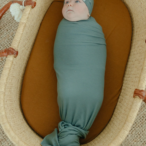 baby swaddled in Moss