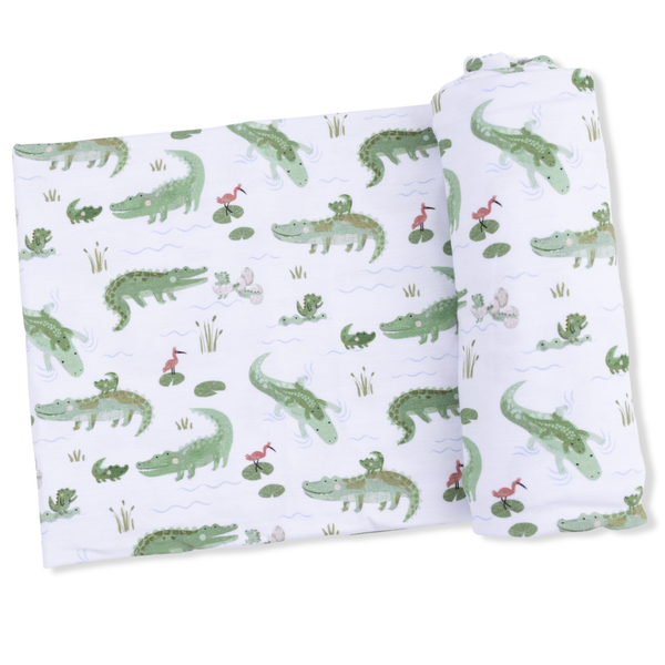 swaddling blanket with alligator print on white

