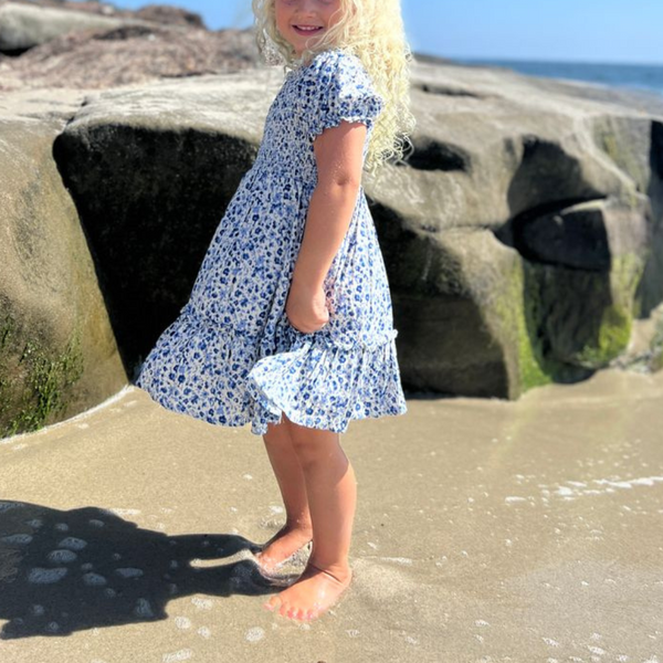 blue floral ruffle dress with smocked bodice and short puff sleeves and a smocked bodice
