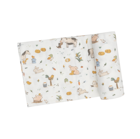 white swaddle blanket with farm animals like horses, chickens, roosters, and pigs