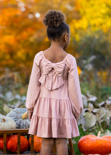 back of long sleeve pink dress with bow on back