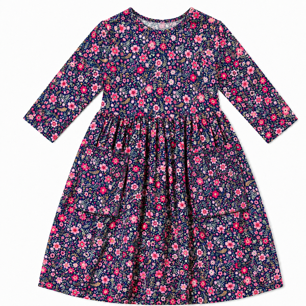 Girl's navy floral twirl dress with bright pink flowers, a classic empire waist, and soft stretchy fabric perfect for everyday wear.