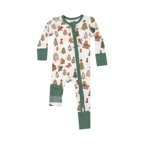 white and green romper with gingerbread riding a sleigh