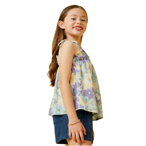 Side view of the floral ruffled tank showing adjustable tie straps and a relaxed, breezy fit.