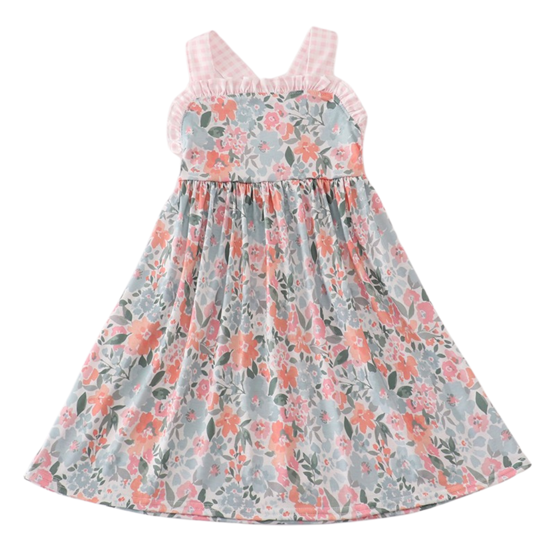 Girl's floral dress with pink gingham straps, ruffle-trim neckline, and gathered skirt in soft coral and green tones.