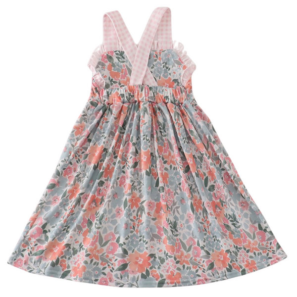 Back of dress showing crisscross gingham straps and elastic waist, with full floral print skirt.