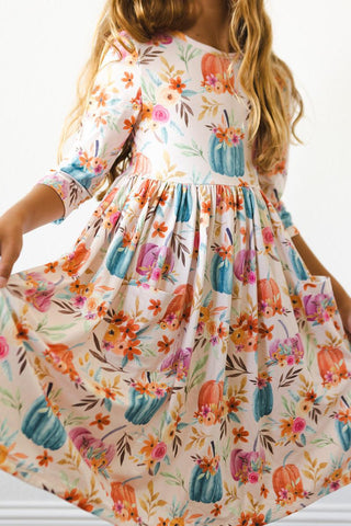 Girls’ twirl dress with ballet neckline and scoop back in soft, colorful fabric—ideal for school, play, and special occasions.
