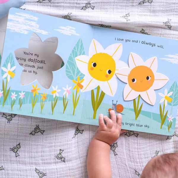 Children's book with daffodil illustrations on a textured fabric background