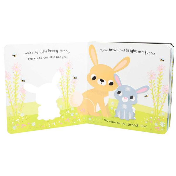 Open book with two cartoon bunnies on a white background
