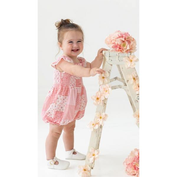 live photo of a little girl wearing the lacy romper