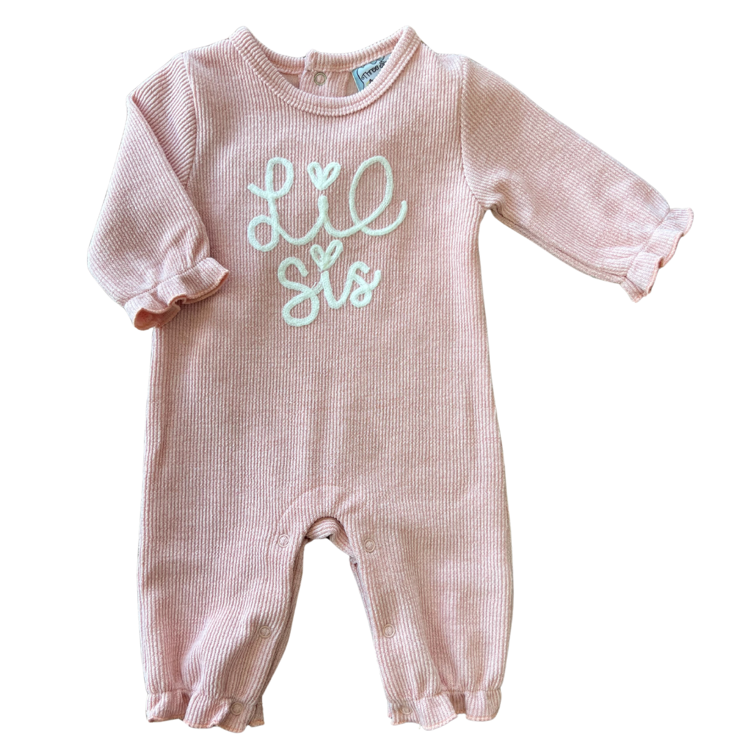 long sleeve light pink heathered knit baby romper with "lil sis" chain stitch embroidery on the front. 