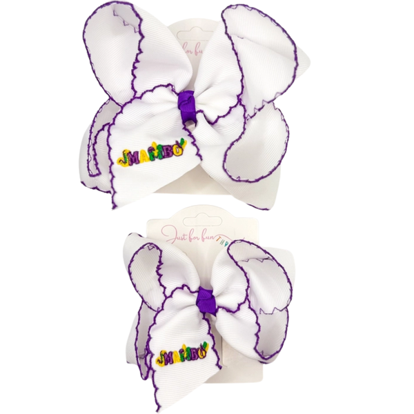 White grosgrain hair bow with purple stitched edges and multicolor “Mambo” embroidery, shown in large and medium sizes.