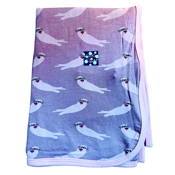 bamboo swaddling blanket in a purply color with light colored sea otter print. 