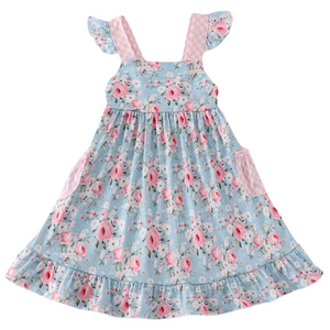 Blue floral dress with pink gingham flutter sleeves, patch pockets, and ruffle hem—perfect for spring and summer outings.