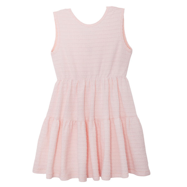 Blush pink textured sleeveless girls dress with tiered skirt and bow back detail on white background