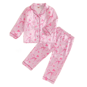 pink satin long sleeve button down shirt and pants set with bows and hearts on it. 