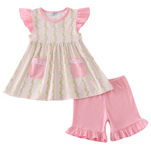 Two-piece girls' outfit with flutter sleeve lemon print top, lace-trimmed pink pockets, and matching ruffle-hem pink shorts.