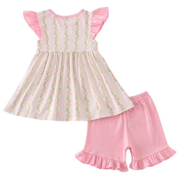 Back of lemon print tunic and pink ruffle shorts set, showing flutter sleeves and gathered swing fit.