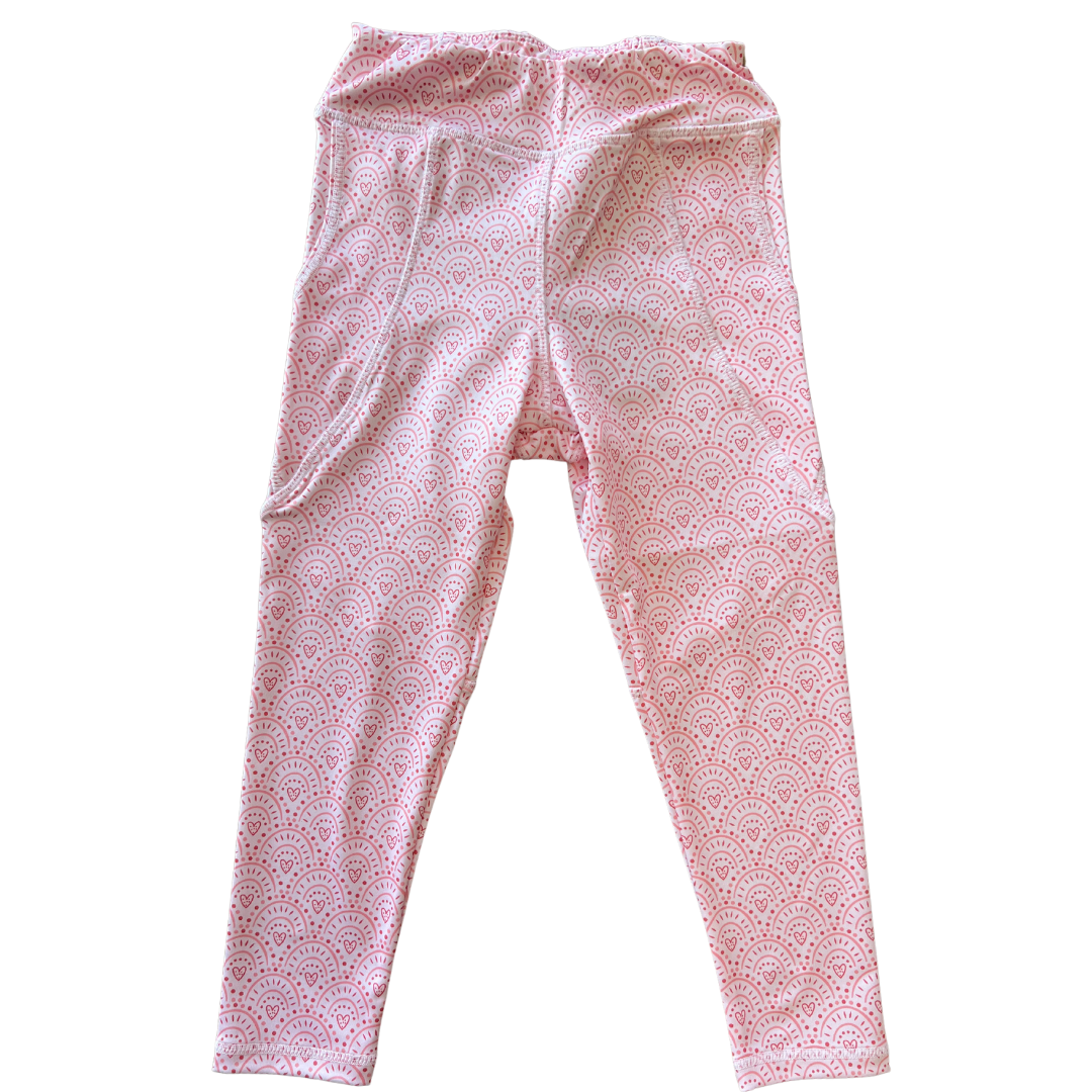 Pink leggings with heart design. 