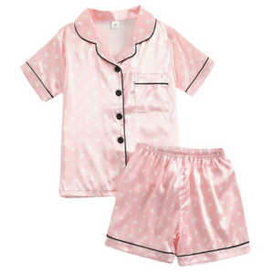 pink short sleeve with buttons and short set with white polka dots.