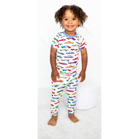 Kids' pajama set with a colorful racing car print, featuring a long-sleeve top and matching pants.