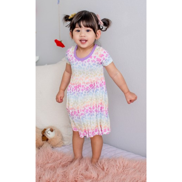 Girls' dress with a vibrant rainbow leopard print, featuring a soft, twirl-worthy silhouette.