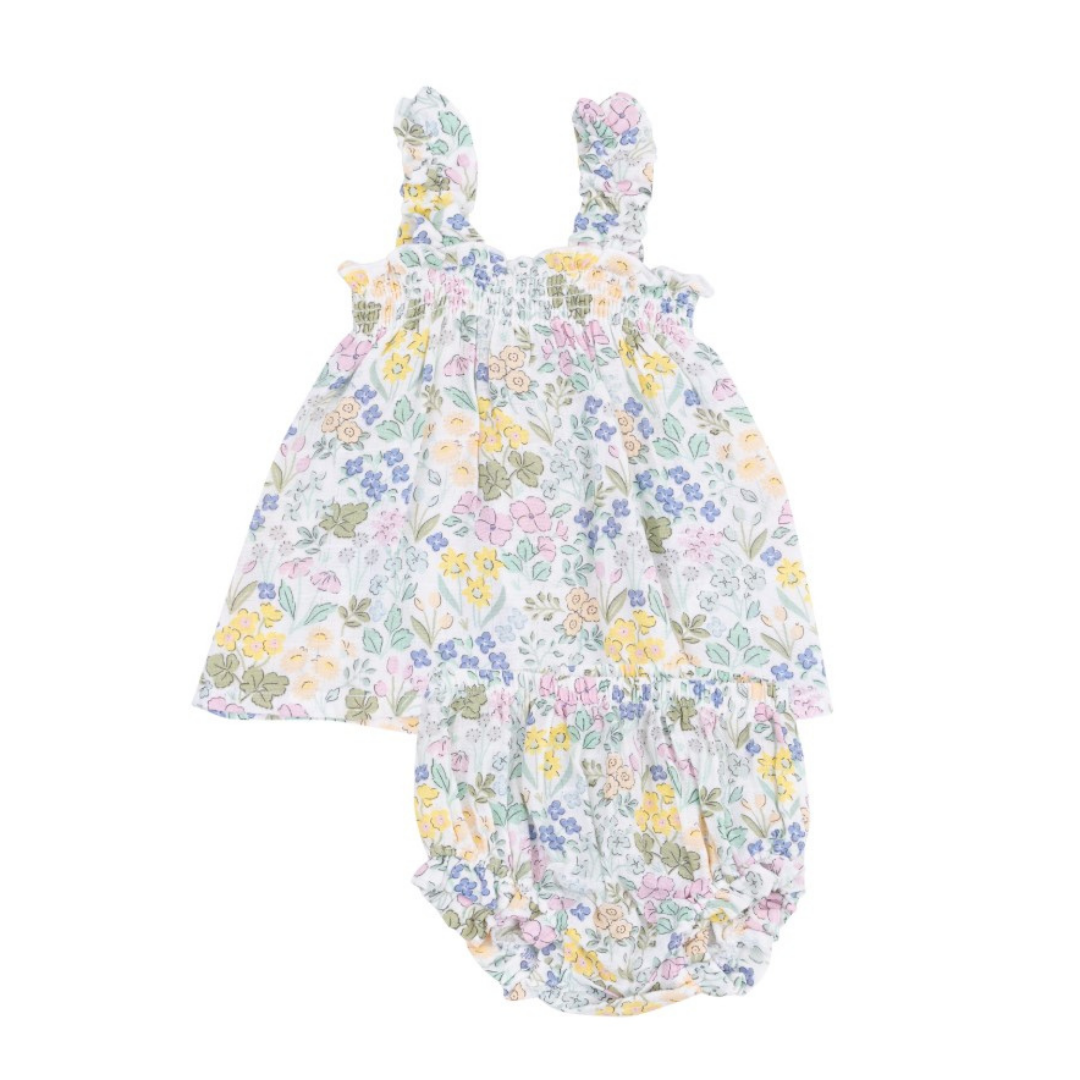white shirt with pink, blue, yellow, and green floral. has ruffle straps and matching bloomers. 