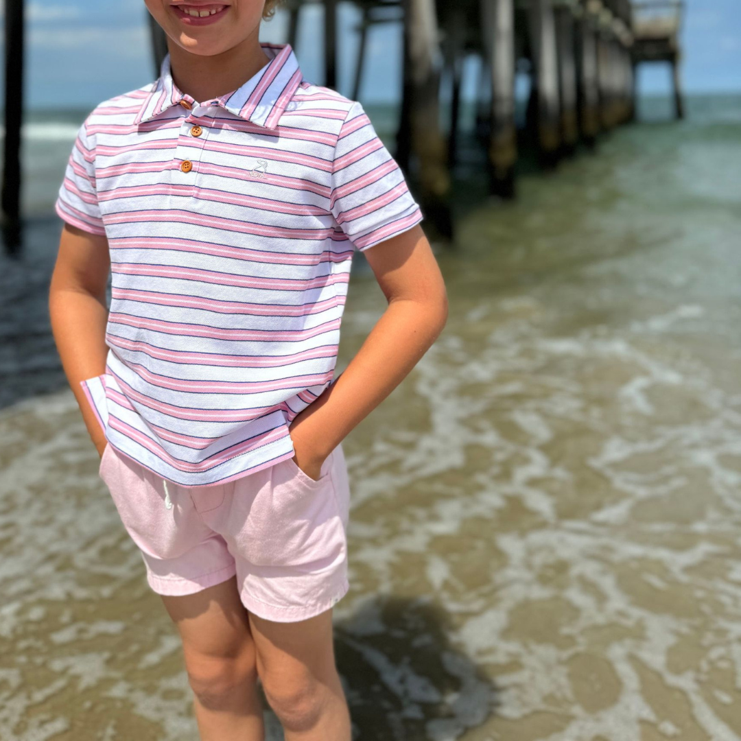 Boys polo in white with wide pink and navy stripes. three button front and collar

