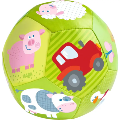 Soft green baby ball with illustrated farm animals, including a pig, cow, sheep, duck, and red tractor.