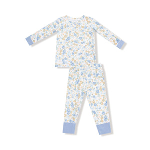 Two-piece kids' pajama set with blue and golden floral calico print, long sleeves, and blue cuff accents on top and pants.

