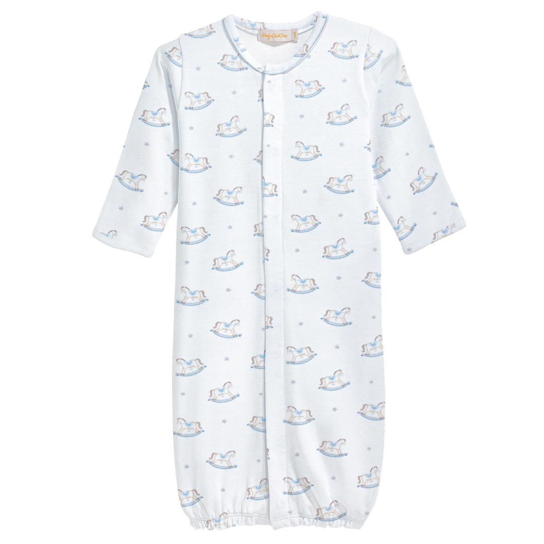 Blue baby converter gown with long sleeves and an allover print of white and blue rocking horses, featuring front snaps and an elastic bottom hem.