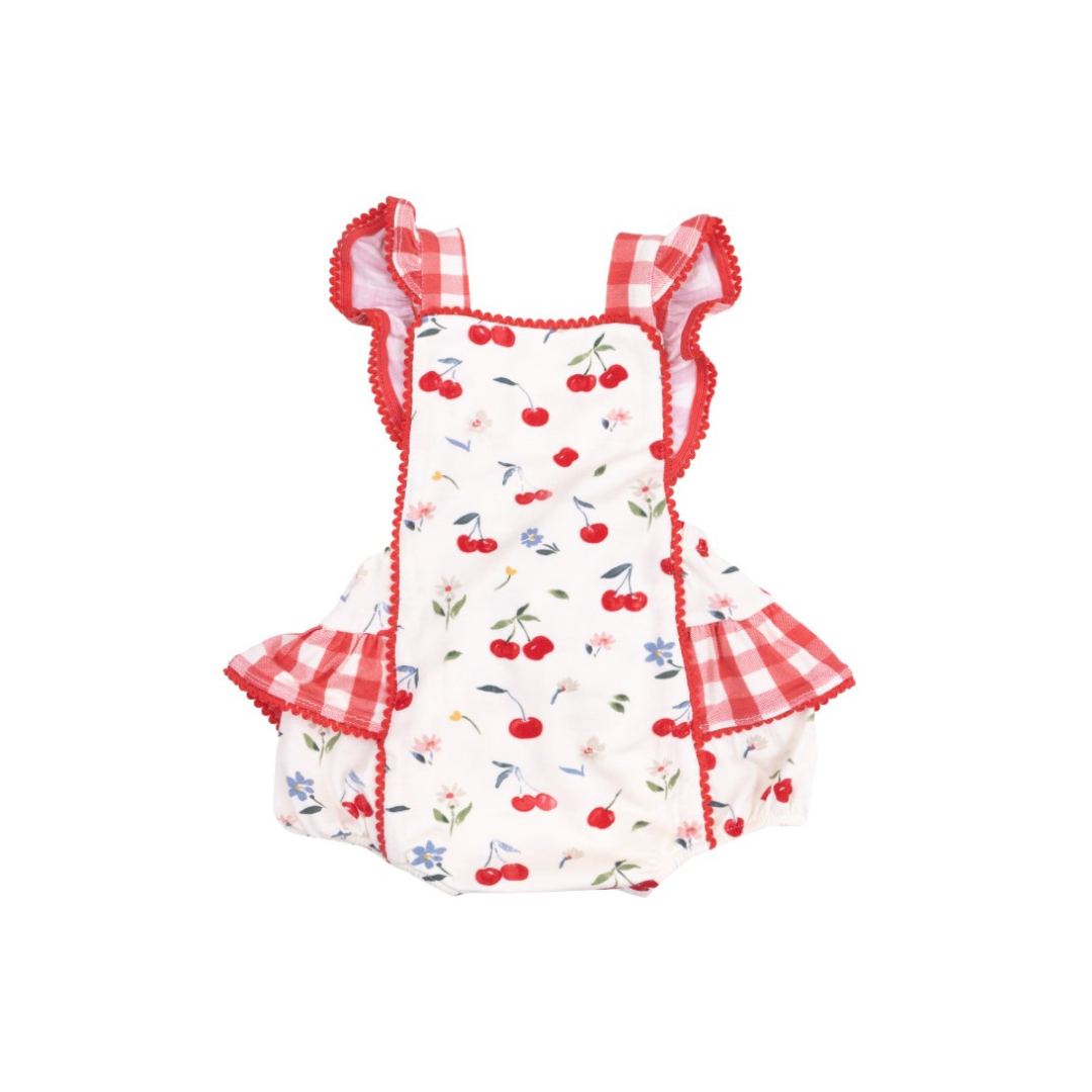 white sunsuit with cherry and flower print and gingham sleeves and ruffles