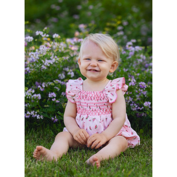 live photo of little girl wearing the light pink romper with watermelon print