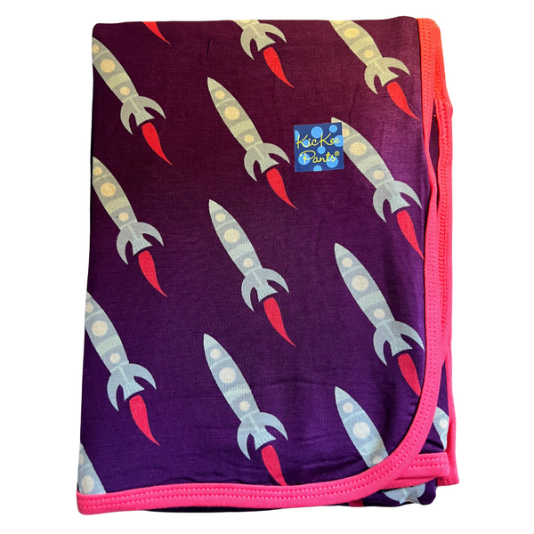 bamboo swaddling blanket in a dark grape color with rocket ships and trimmed in pink