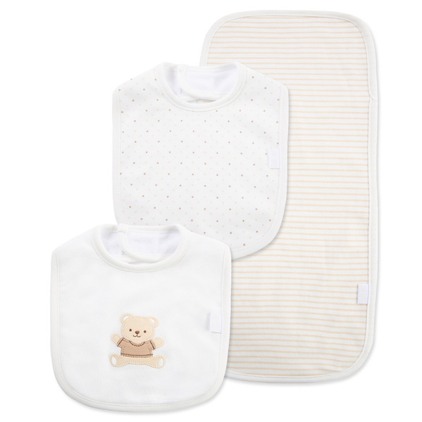 Front view of neutral baby feeding set with two bibs and matching burp cloth, featuring an embroidered teddy bear bib, tan micro-dot bib, and coordinating tan striped burp cloth.
