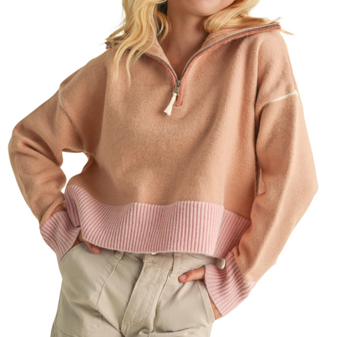 Orange quarter zip sweater with a pink hemline and pink sleeveline. 
