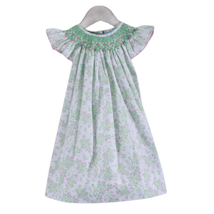 white zoey dress with green smocked neckline with pink blossoms